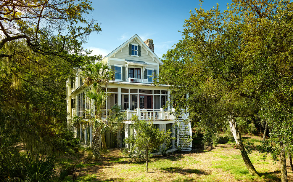 Photo of a medium sized and green nautical house exterior in Charleston with three floors, wood cladding and a pitched roof.
