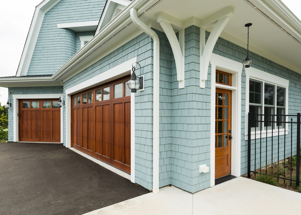 Design ideas for a large and blue traditional house exterior in Milwaukee with wood cladding.