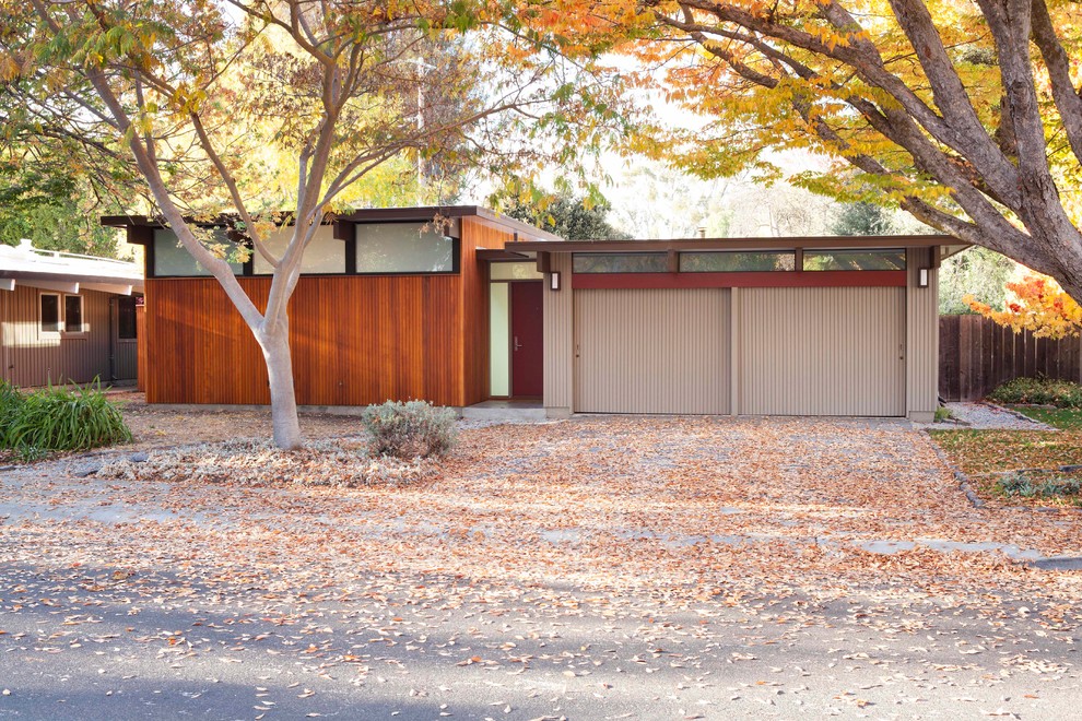 Photo of a midcentury house exterior in San Francisco with wood cladding and a flat roof.