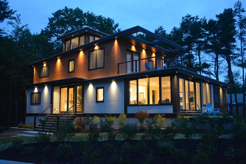 Ejemplo de fachada de casa multicolor moderna de tamaño medio de tres plantas con revestimiento de aglomerado de cemento y tejado de un solo tendido