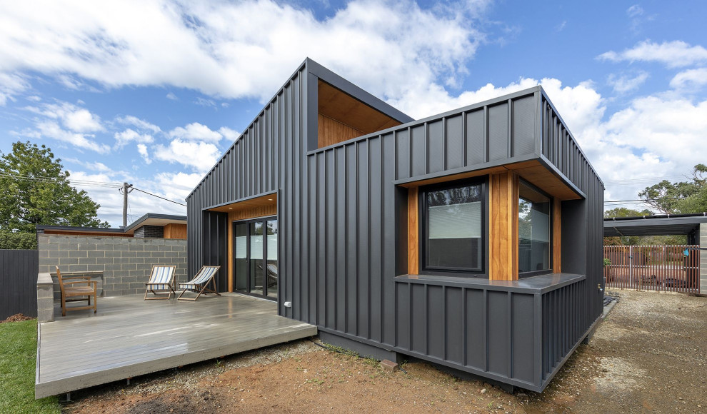 Example of a small trendy one-story mixed siding house exterior design in Canberra - Queanbeyan with a metal roof