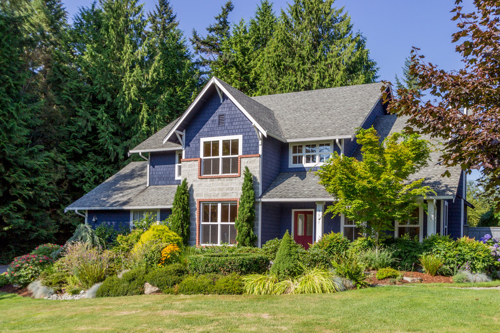 Inspiration for a large timeless blue two-story wood gable roof remodel in Seattle