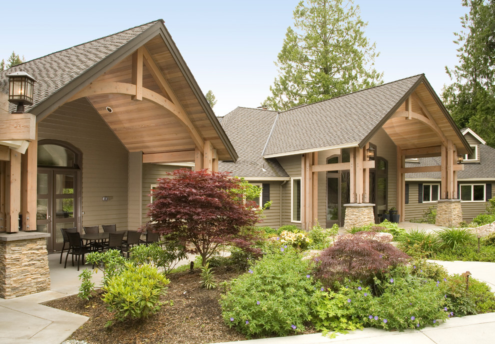 Inspiration for a large timeless brown two-story wood exterior home remodel in Seattle with a hip roof
