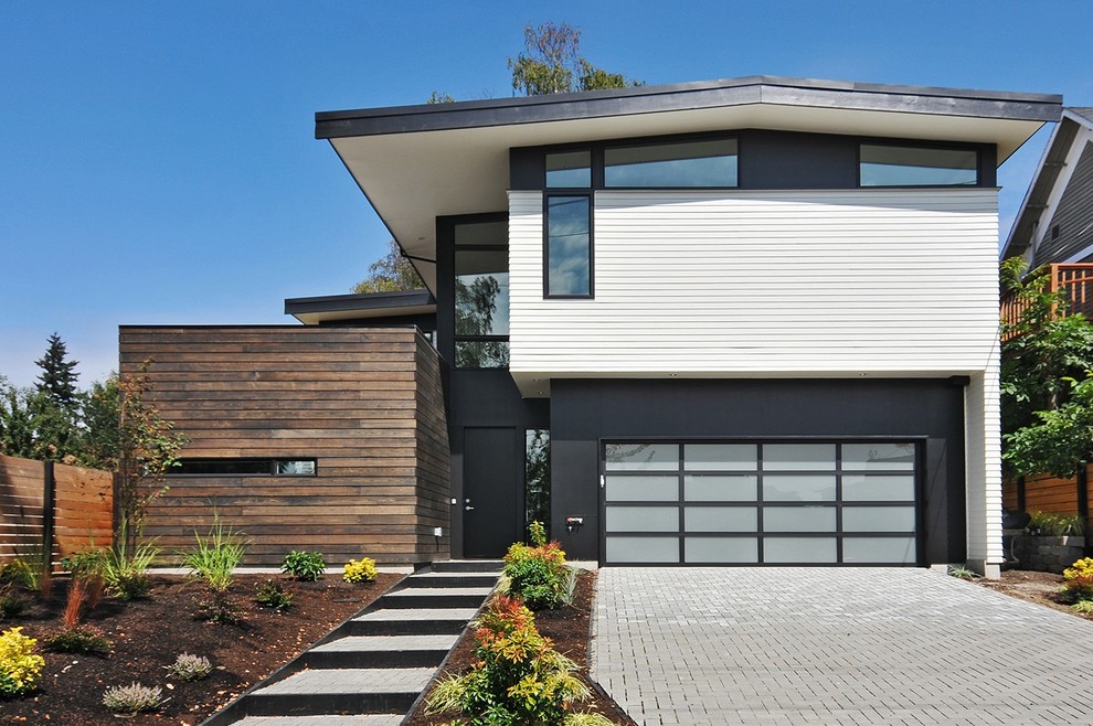 Large and white retro two floor detached house in Seattle with wood cladding.