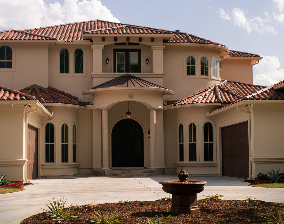 Inspiration for a large and beige two floor render house exterior in Dallas with a tiled roof.