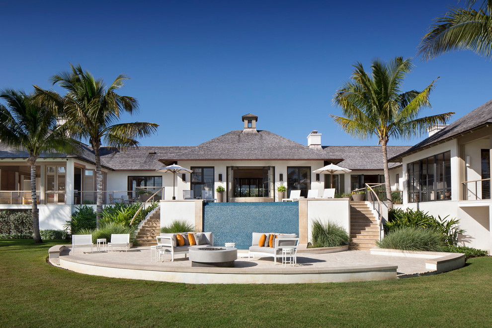 Beach style white house exterior photo in Other with a hip roof and a shingle roof