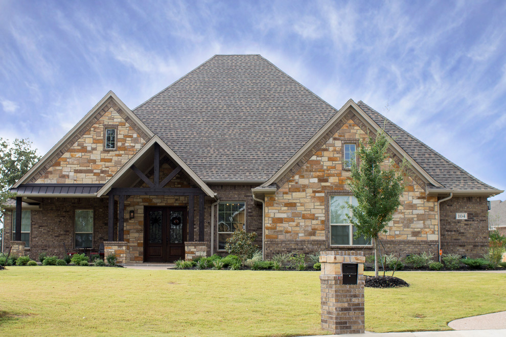 Design ideas for a large and beige traditional two floor brick detached house in Dallas with a hip roof and a shingle roof.