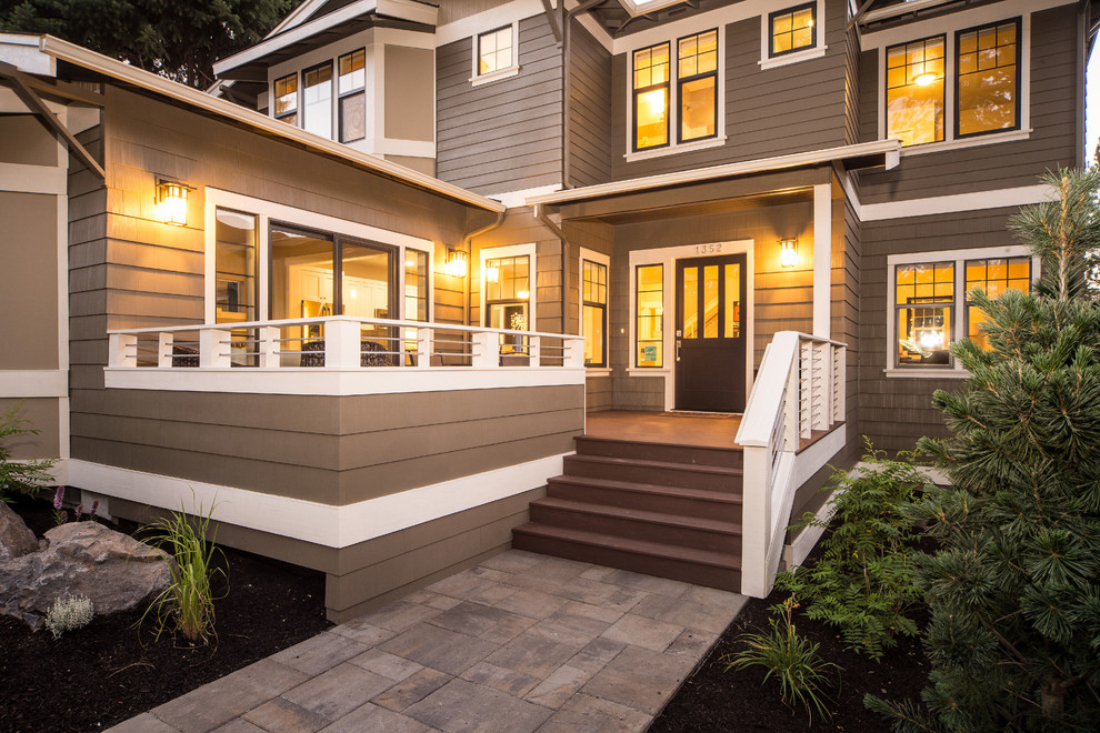This is an example of a large and gey classic two floor house exterior in Seattle with wood cladding and a pitched roof.