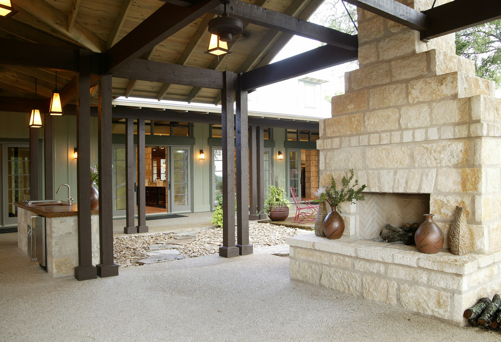 Example of a large classic green one-story stone exterior home design in Austin