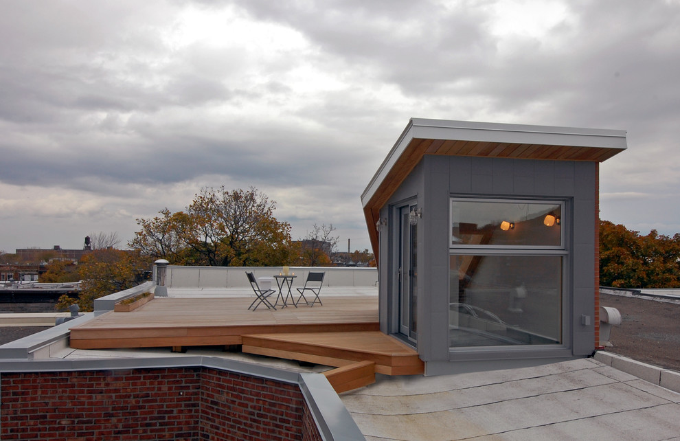 Kleines Nordisches Wohnung mit Metallfassade, grauer Fassadenfarbe, Pultdach und Blechdach in Montreal