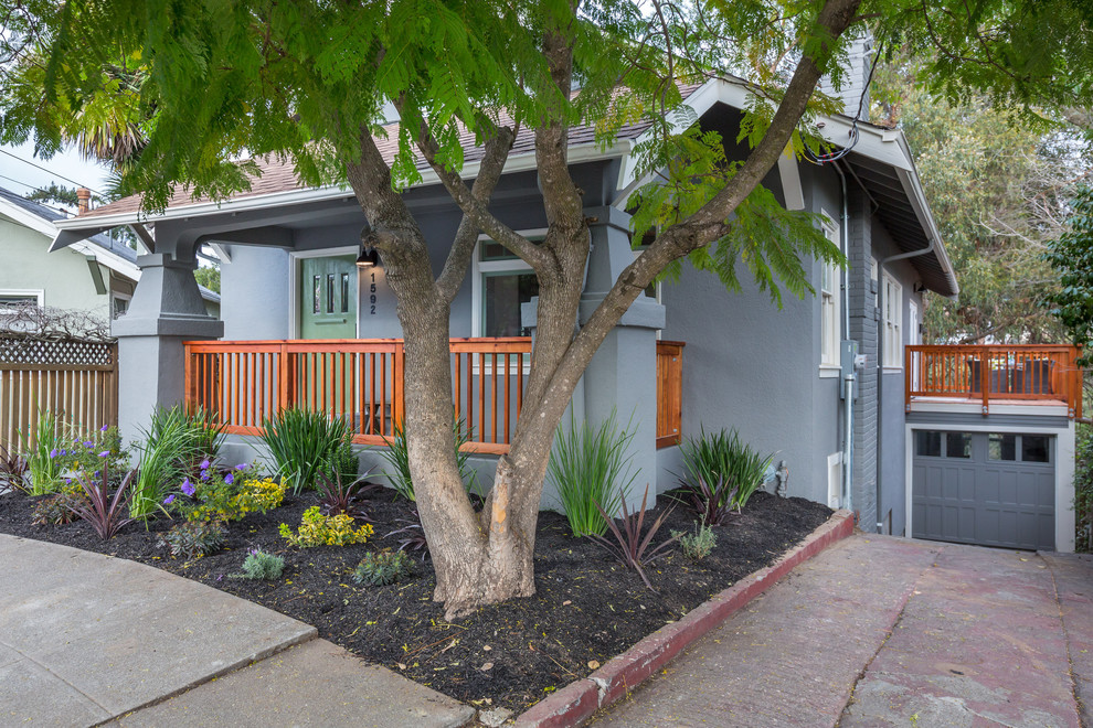 Example of a mid-sized eclectic gray two-story stucco exterior home design in San Francisco