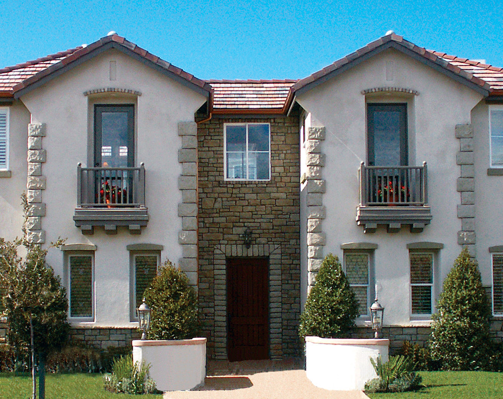 Large traditional two floor house exterior in Orange County with stone cladding.