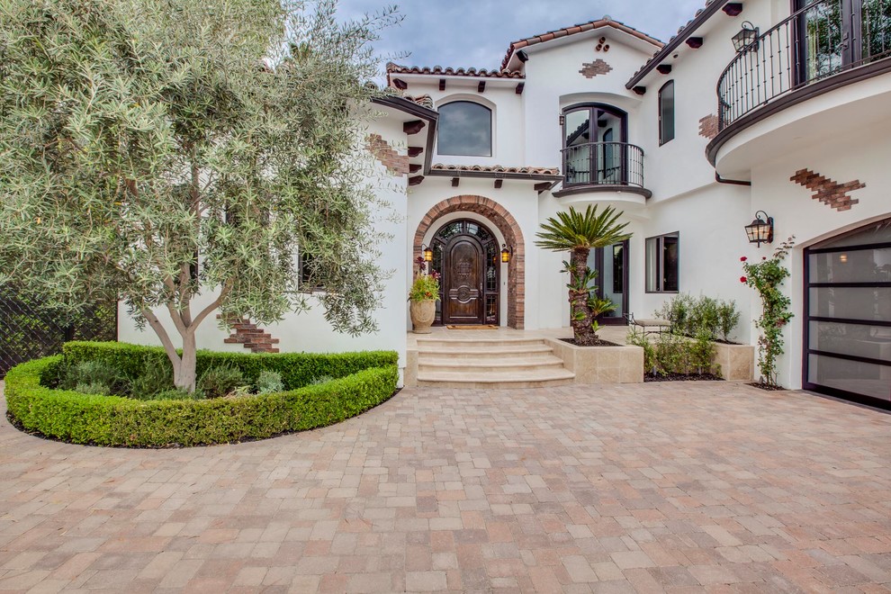Mediterranean white two-story stucco exterior home idea in Los Angeles