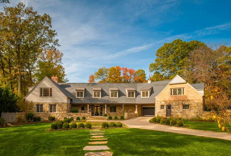 Large elegant beige two-story stone exterior home photo in DC Metro