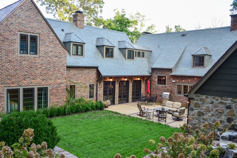 Example of a mid-sized classic red two-story brick exterior home design