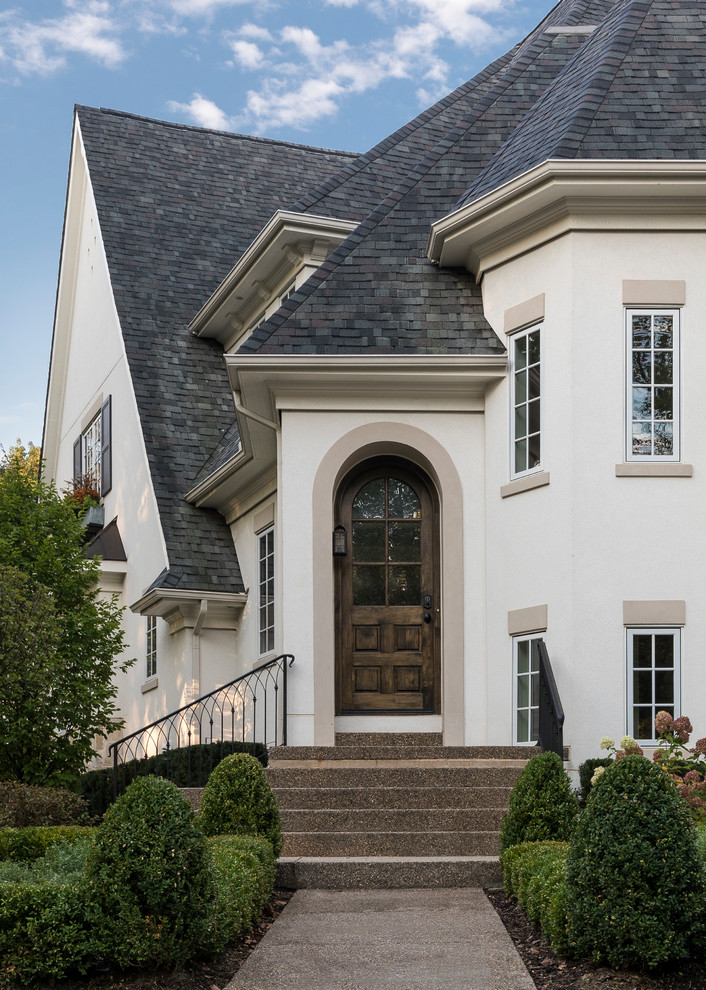 Inspiration for a large transitional two-story stucco house exterior remodel in Detroit