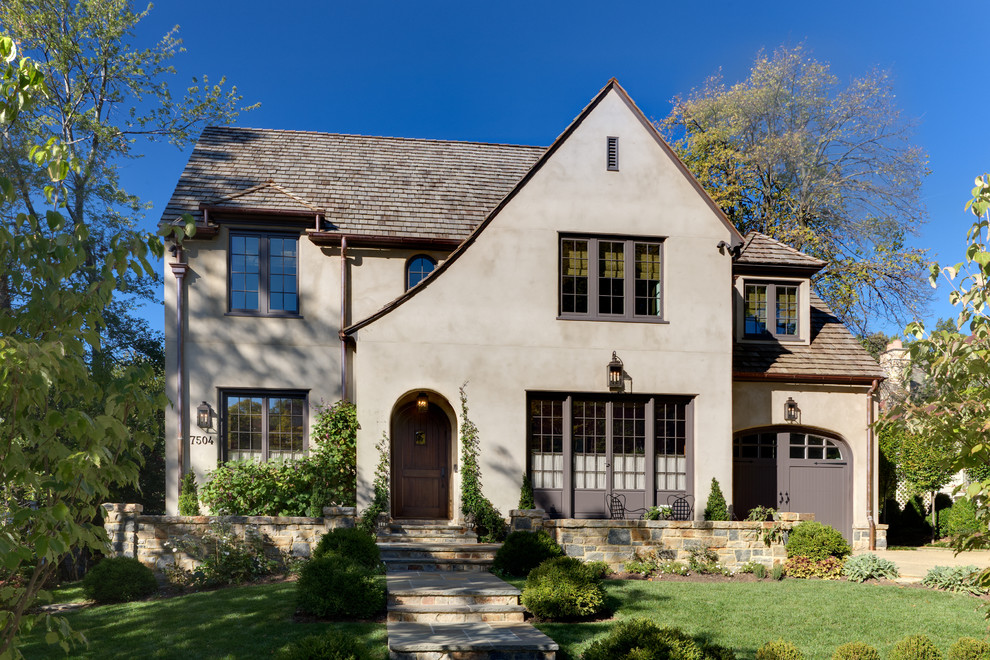 Example of a classic gray two-story stucco exterior home design in DC Metro