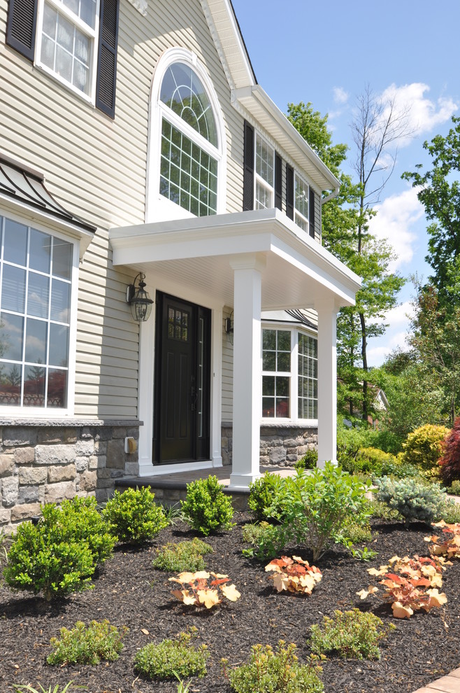 Medium sized and green classic two floor house exterior in Philadelphia with stone cladding.
