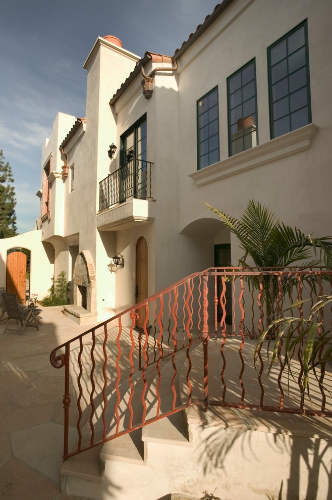Inspiration for a small and white mediterranean render house exterior in Santa Barbara with three floors.