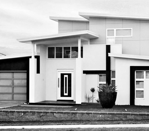 Photo of a large and white contemporary two floor house exterior in Other with mixed cladding.