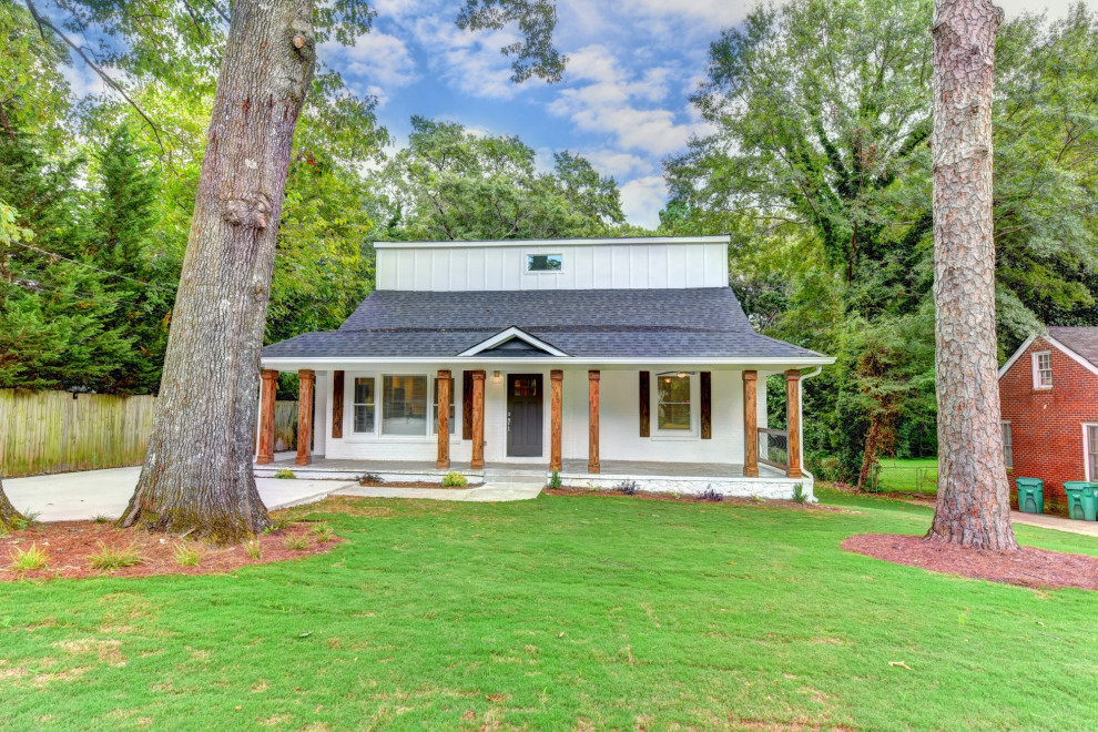 This is an example of a medium sized and white traditional two floor detached house in Atlanta with concrete fibreboard cladding, a hip roof and a shingle roof.