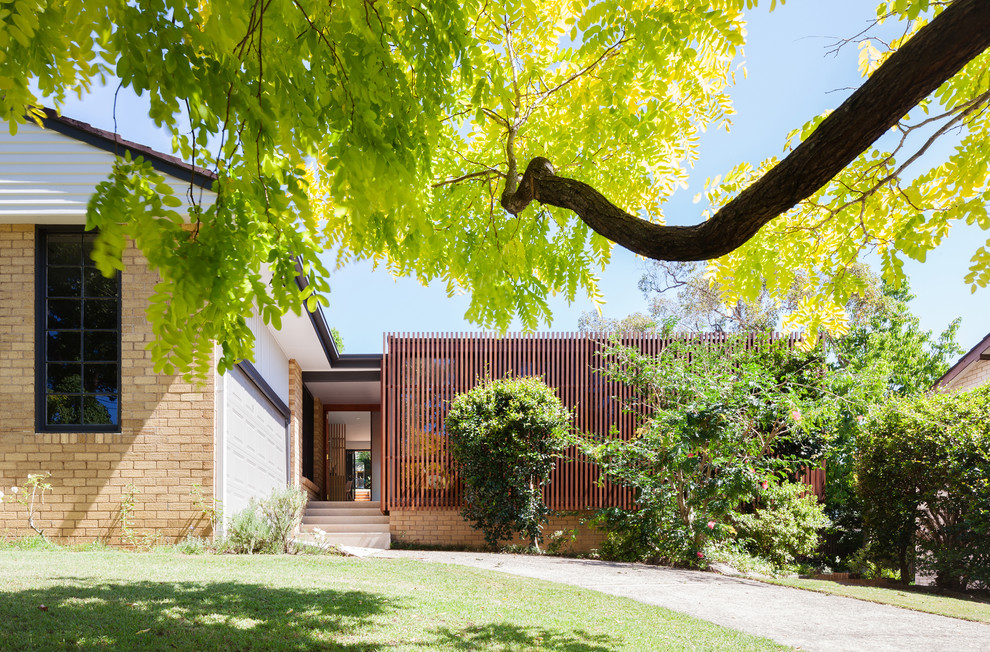 Inspiration for a medium sized and brown contemporary bungalow house exterior in Sydney with wood cladding.