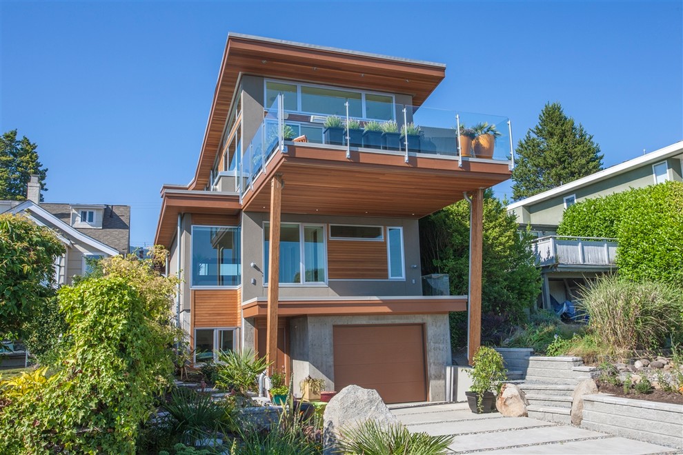 Design ideas for a contemporary house exterior in Vancouver with wood cladding.