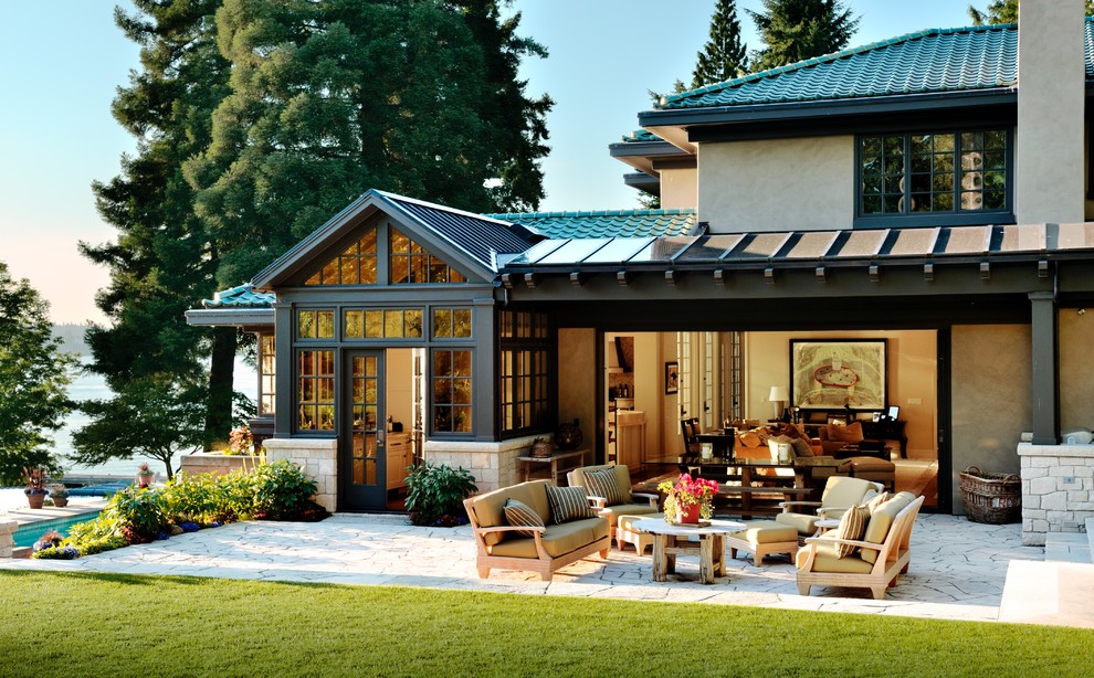 Design ideas for an expansive and beige traditional render house exterior in Seattle with three floors and a hip roof.