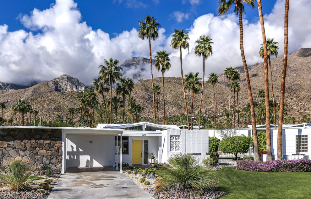 Inspiration for a large mid-century modern white one-story mixed siding exterior home remodel in Other