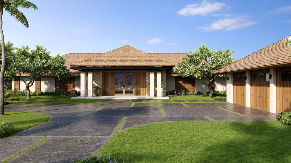 This is an example of an expansive and beige bungalow render detached house in Hawaii with a hip roof and a shingle roof.