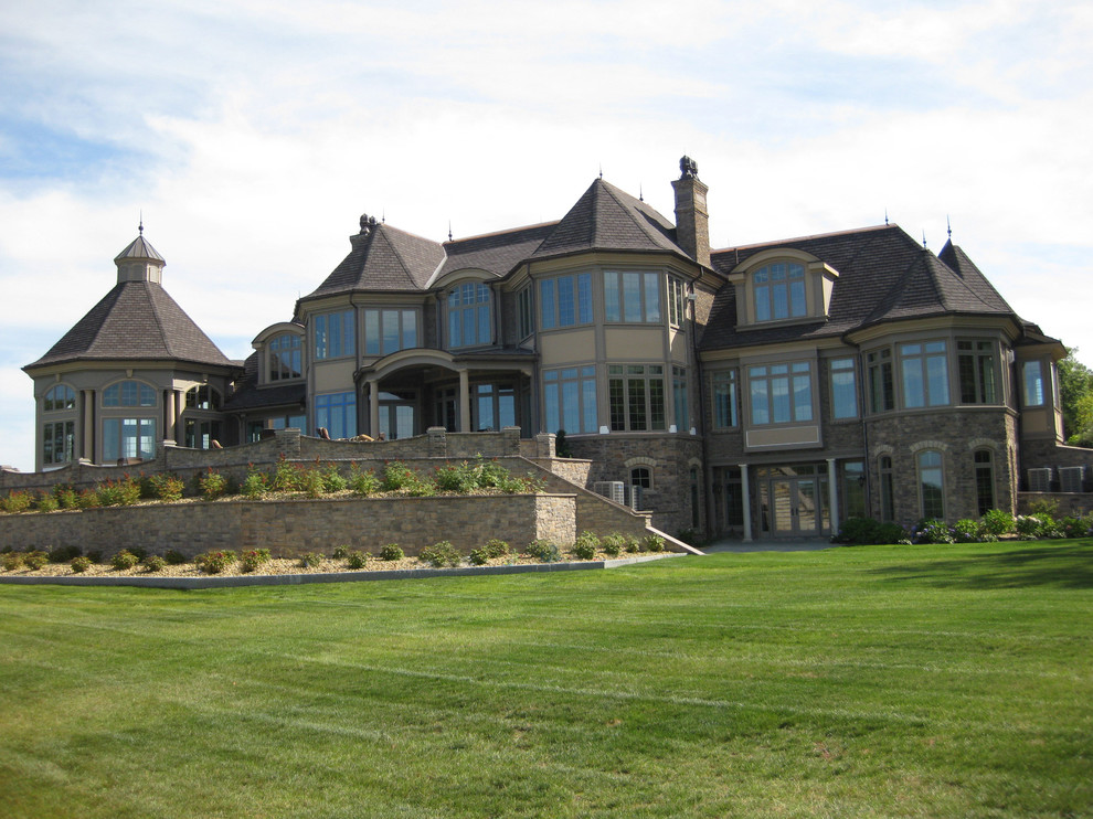 Inspiration for a huge craftsman brown three-story stone exterior home remodel in Boston with a tile roof