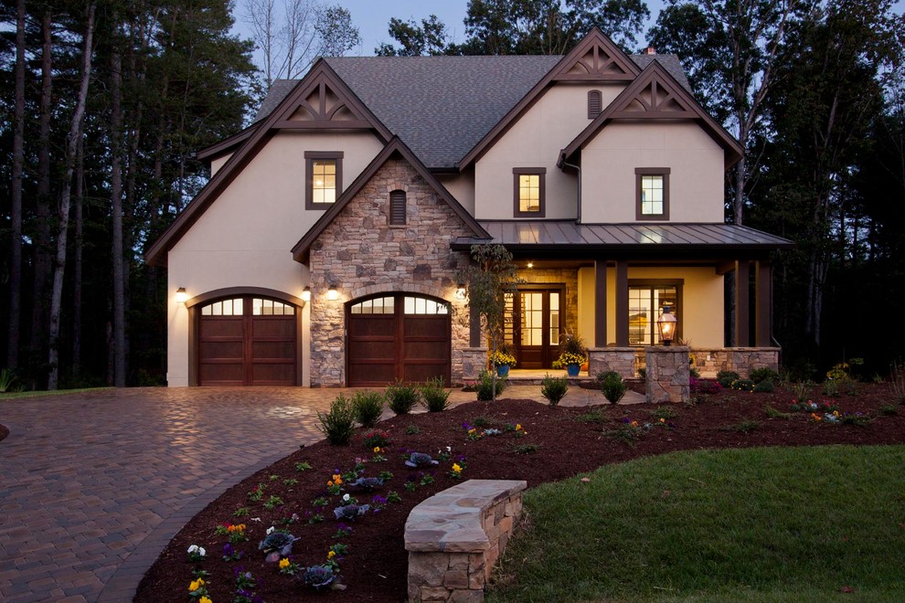 Large transitional beige three-story stucco exterior home photo in Other with a shingle roof