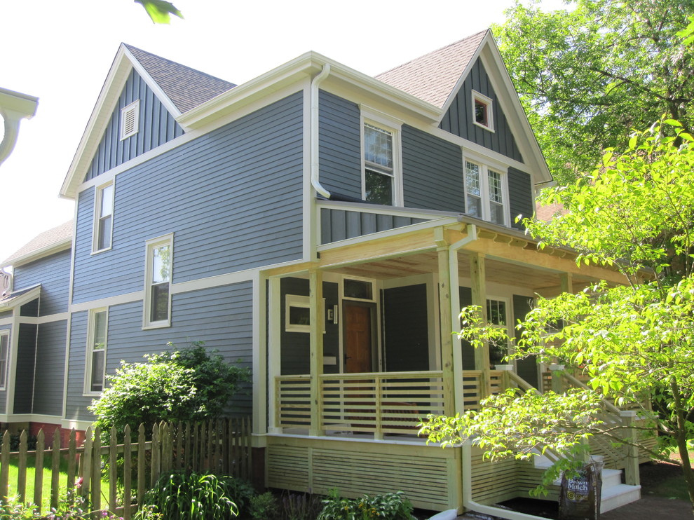 Example of a mid-sized cottage blue two-story concrete fiberboard exterior home design in Other with a metal roof