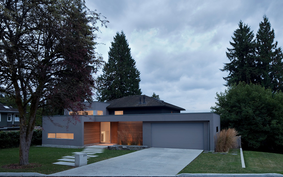 Inspiration for a medium sized and gey modern split-level house exterior in Vancouver with a flat roof and mixed cladding.