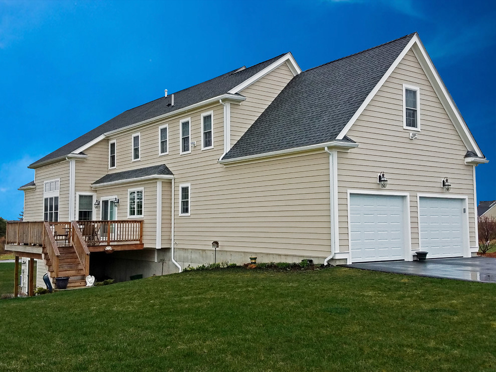 Inspiration for a large timeless beige two-story mixed siding exterior home remodel in Boston with a shingle roof