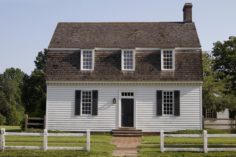 Small and white country two floor house exterior in Other with wood cladding.