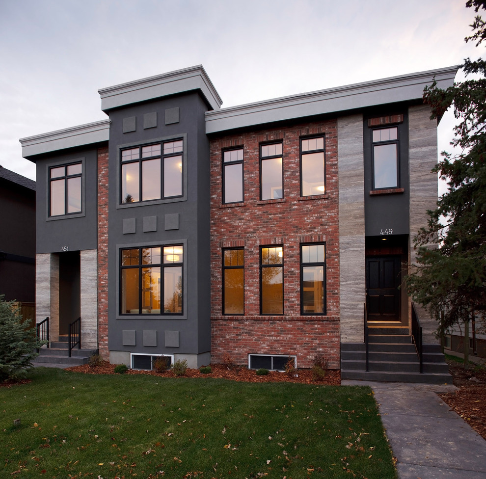 Immagine della facciata di una casa bifamiliare contemporanea a due piani con rivestimento in mattoni