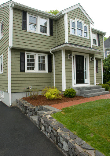 Example of a mid-sized classic green two-story vinyl exterior home design in Boston
