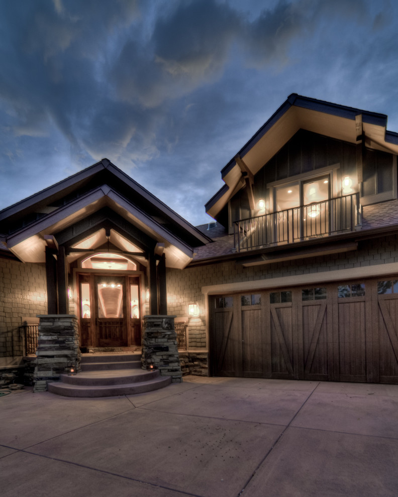 Design ideas for a rustic house exterior in Denver with wood cladding.