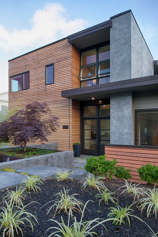 Large modern two-story mixed siding flat roof idea in Seattle