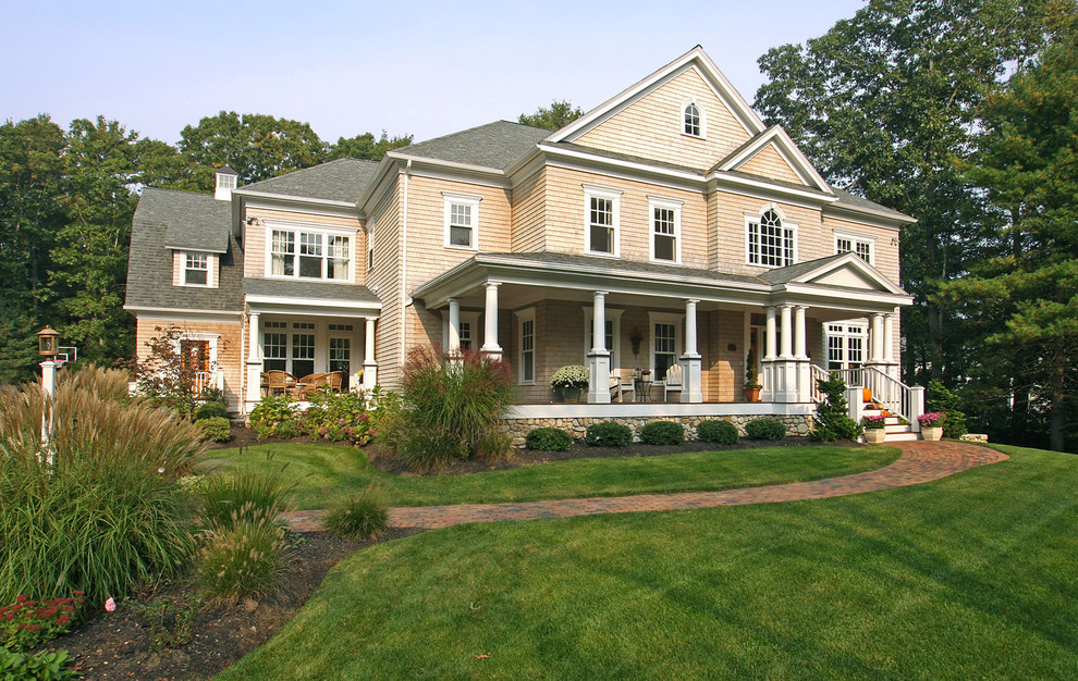 Inspiration for a large timeless beige three-story wood exterior home remodel in Boston