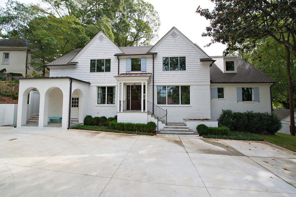 Photo of a medium sized and white bohemian two floor house exterior in Atlanta with mixed cladding and a hip roof.