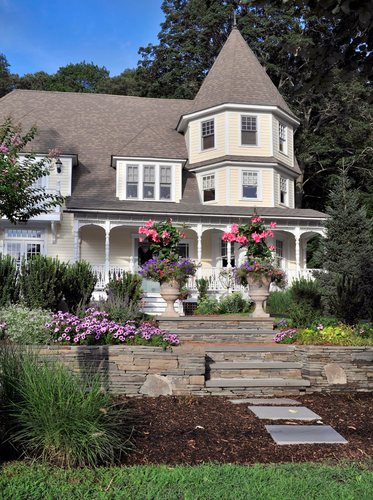 Victorian yellow three-story wood exterior home idea in New York