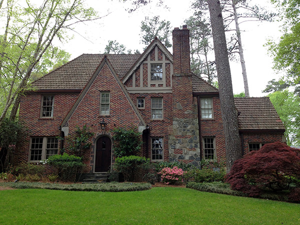 Large elegant red two-story brick exterior home photo in Atlanta