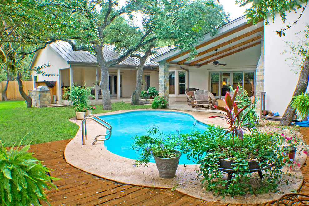 Mid-sized mediterranean beige one-story stucco gable roof idea in Austin