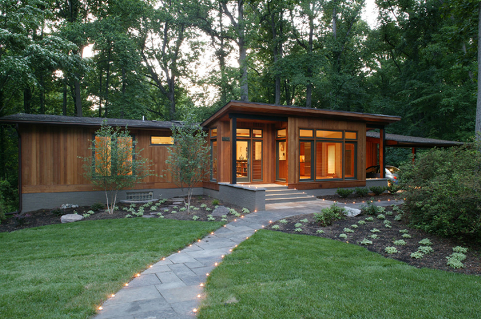 Inspiration for a medium sized and beige modern bungalow house exterior in DC Metro with wood cladding and a lean-to roof.