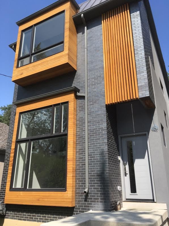 Photo of a large and gey bohemian two floor detached house in Toronto with wood cladding, a flat roof and a metal roof.