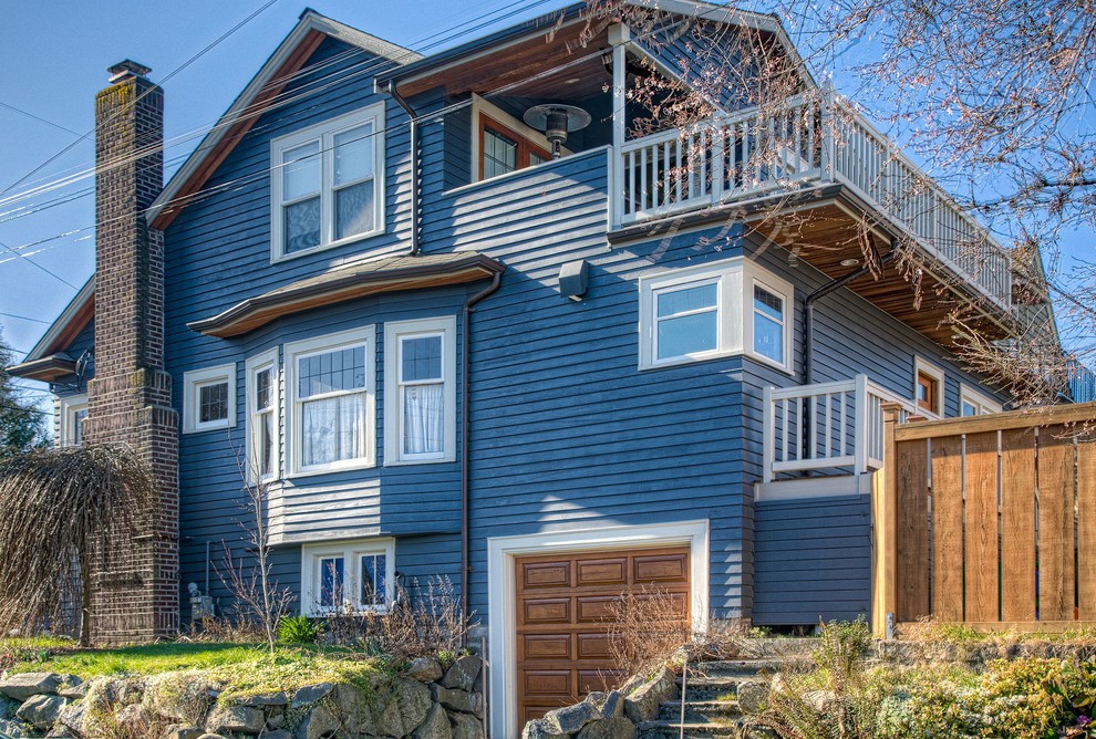 Inspiration for a large and blue traditional two floor house exterior in Seattle with wood cladding.