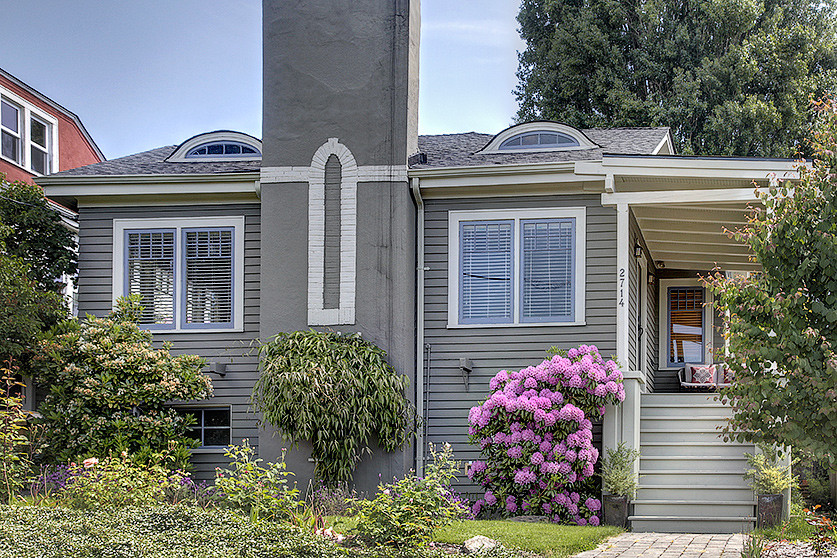 Photo of a small and gey classic bungalow house exterior in Seattle with wood cladding.