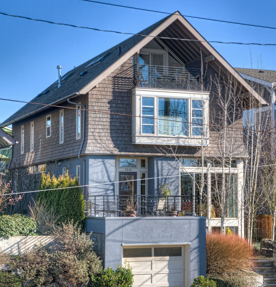 This is an example of a large and brown bohemian house exterior in Seattle with three floors and mixed cladding.